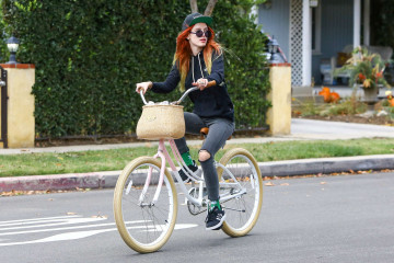 Bella Thorne in Ripped Jeans Riding a Bike in Sherman Oaks фото №926088