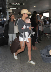 Nina Dobrev in Shorts Arriving at LAX Airport in LA фото №945834