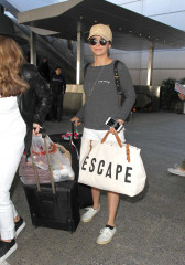 Nina Dobrev in Shorts Arriving at LAX Airport in LA фото №945831